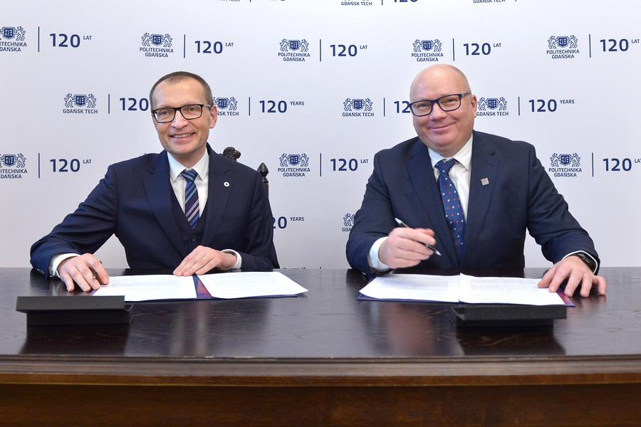 Rektor Uniwersytetu SWPS i Rektor Politechniki Gdańskiej siedzący koło siebie, podpisujący umowę